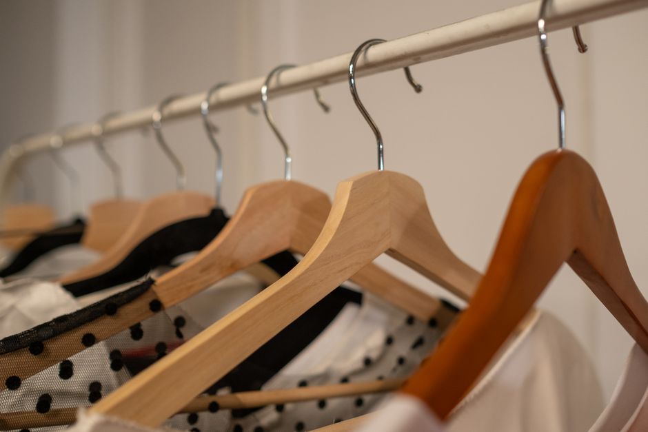 Wooden wardrobe with hanging clothes